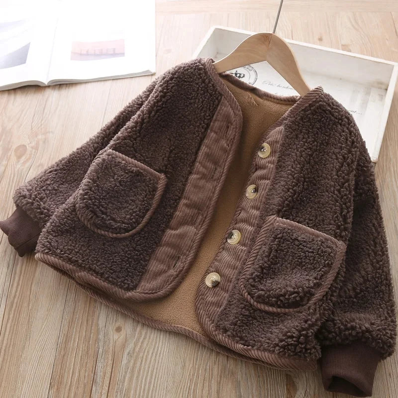 Brown fleece jacket with pockets on a wooden surface