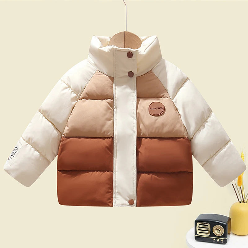 Children's puffer jacket with beige and brown color block design on a light yellow background.
